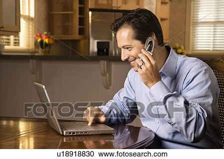 Man on Cell Phone and Laptop View Large Photo Image Stock Image - Man on Cell Phone and Laptop. Fotosearch