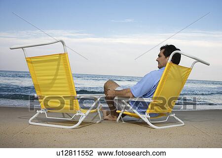 Man Sitting on Beach Alone View Large Photo Image Stock Image - Man Sitting on Beach Alone. Fotosearch