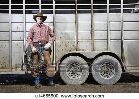 Man Wearing Cowboy Hat Holding Lariat View Large Photo Image Stock Image - Man Wearing Cowboy Hat Holding Lariat. Fotosearch