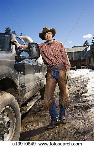 Man Wearing Cowboy Hat Standing Beside Truck View Large Photo Image Stock Photo - Man Wearing Cowboy Hat Standing Beside Truck. Fotosearch