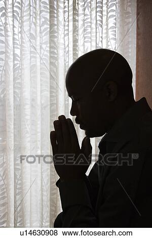 Stock Photo - Man With Hands in Prayer. Fotosearch