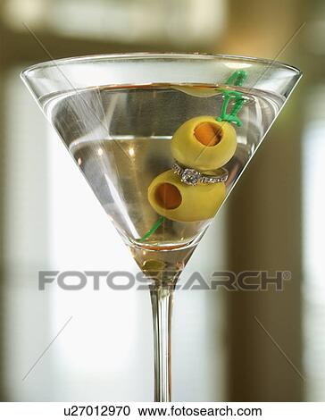 Stock Image - Martini Holding Engagement Ring. Fotosearch