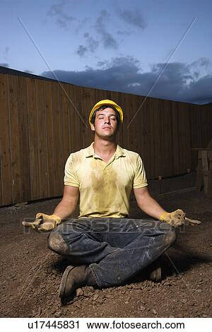 Stock Image - Meditating Construction Worker. Fotosearch