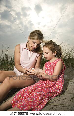 Mother and Daughter Looking at Shells View Large Photo Image Stock Photography - Mother and Daughter Looking at Shells. Fotosearch