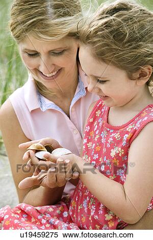 Mother and Daughter Looking at Shells View Large Photo Image Stock Photography - Mother and Daughter Looking at Shells. Fotosearch