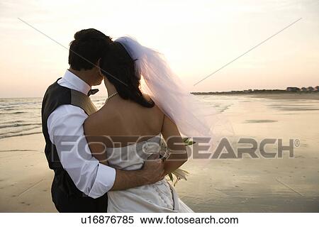 Stock Photography - Newlywed Couple on Beach. Fotosearch
