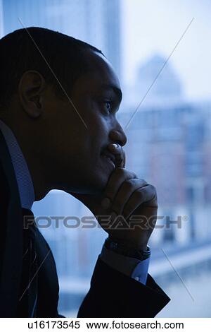 Stock Photography - Pensive Businessman By Window. Fotosearch