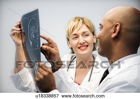 Stock Photo - Physicians analyzing xray.. Fotosearch