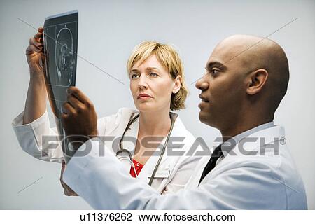 Physicians reading xray. View Large Photo Image Stock Image - Physicians reading xray.. Fotosearch