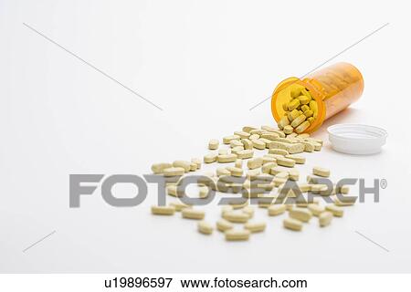 Stock Photo - Pills Spilling From Bottle. Isolated. Fotosearch