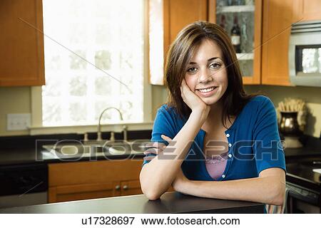 Pretty woman in kitchen View Large Photo Image Stock Photo - Pretty woman in kitchen. Fotosearch