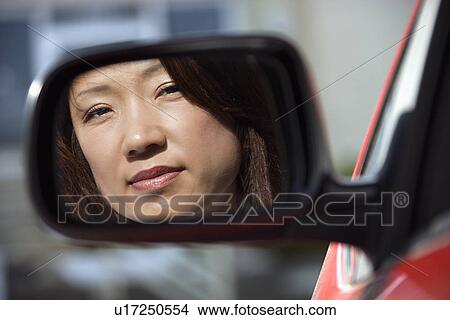 Serious woman in car mirror View Large Photo Image Picture - Serious woman in car mirror. Fotosearch