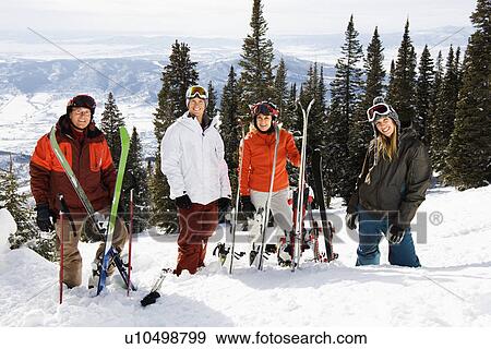 Skiers Standing in Snow Smiling View Large Photo Image Stock Photo - Skiers Standing in Snow Smiling. Fotosearch