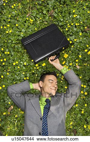 Picture - Smiling Businessman in Flower Patch. Fotosearch