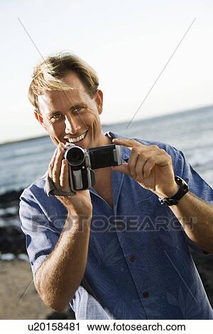Smiling Man With Video Camera View Large Photo Image Stock Image - Smiling Man With Video Camera. Fotosearch