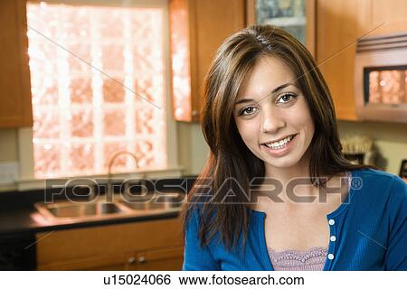 Stock Photograph - Smiling woman in kitchen. Fotosearch