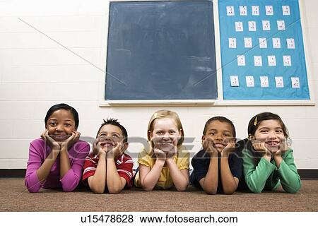 Students Lying on Floor in Classroom. View Large Photo Image Stock Photo - Students Lying on Floor in Classroom. . Fotosearch