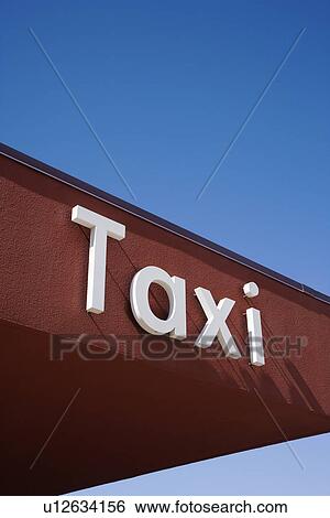 Stock Photograph - Taxi Sign On a Brown Wall. Fotosearch