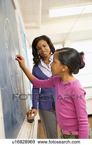 Stock Photo - Teacher and Student at Blackboard. Fotosearch