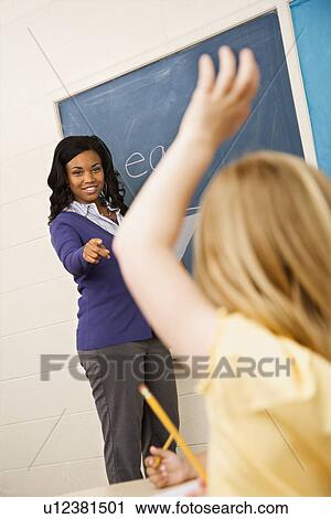Stock Image - Teacher Calling on Student. Fotosearch