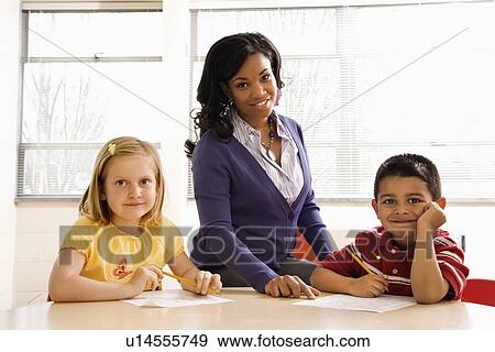 Stock Photo - Teacher Helping Students With Schoolwork . Fotosearch