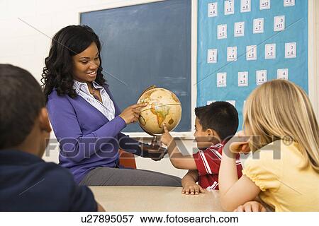 Stock Photo - Teacher Holding Globe. Fotosearch