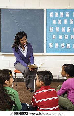Stock Image - Teacher Reading to Students. Fotosearch