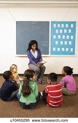 Stock Photography - Teacher Reading to Students. Fotosearch