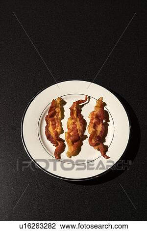 Three Strips of Cooked Bacon on White Plate View Large Photo Image Stock Image - Three Strips of Cooked Bacon on White Plate. Fotosearch