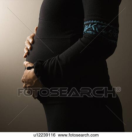 Stock Photograph - Torso of Pregnant Woman. Fotosearch