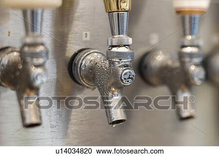 Stock Image - Trio of Beer Tap Spouts. Fotosearch
