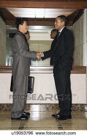 Stock Photograph - Two Businessmen Shaking Hands. Fotosearch