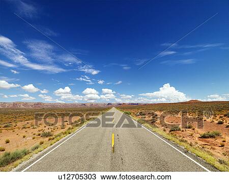 Stock Image - Two Lane Highway Through Desert. Fotosearch