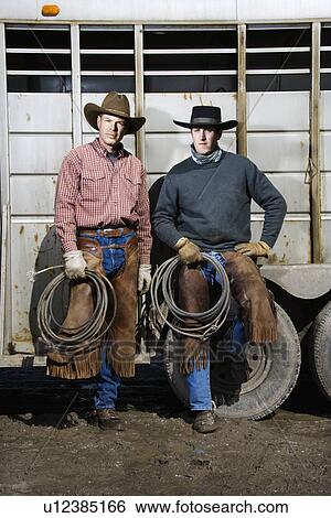 Two Men Wearing Cowboy Hats Holding Lariats View Large Photo Image Stock Photograph - Two Men Wearing Cowboy Hats Holding Lariats. Fotosearch