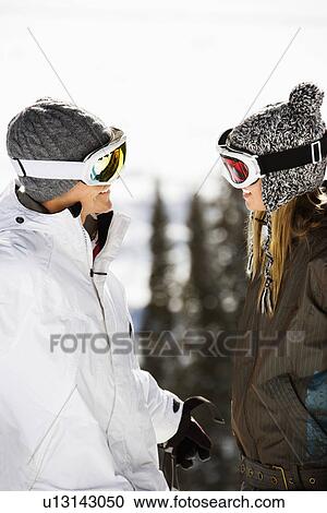 Stock Image - Two Skiers Smiling at Each Other. Fotosearch