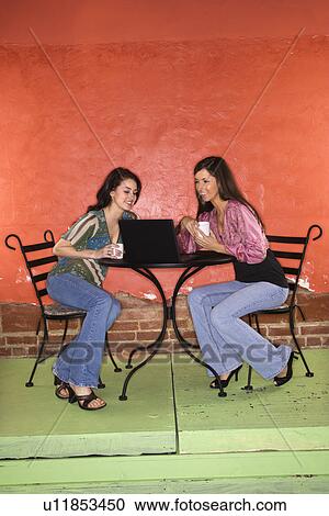Stock Image - Two Young Women Having Coffee. Fotosearch