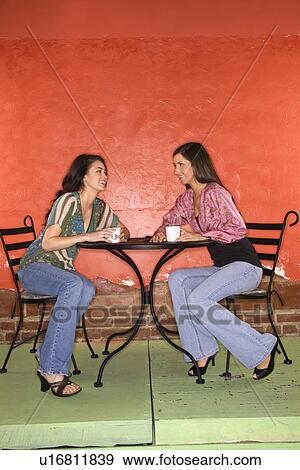 Stock Photo - Two Young Women Having Coffee. Fotosearch