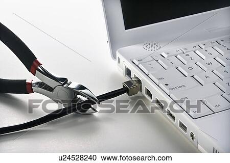 Stock Image - Wire Cutters Cutting Cable to Laptop. Fotosearch