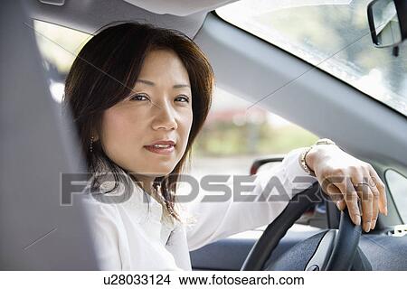 Picture - Woman at steering wheel. Fotosearch