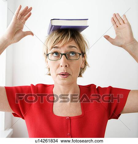 Woman balancing book on her head. View Large Photo Image Picture - Woman balancing book on her head.. Fotosearch