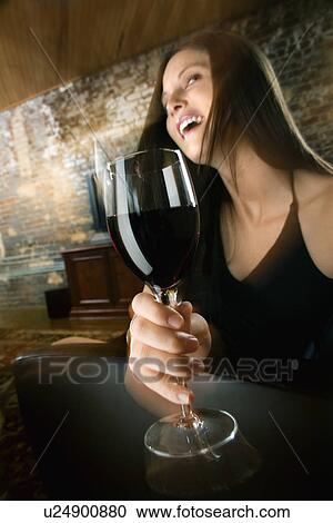 Stock Image - Woman drinking and laughing. Fotosearch