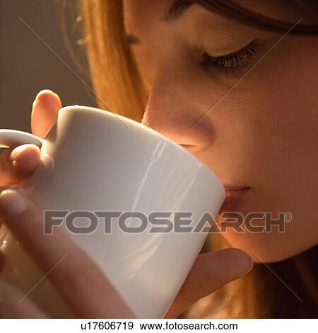 Woman drinking from cup View Large Photo Image Stock Photo - Woman drinking from cup. Fotosearch