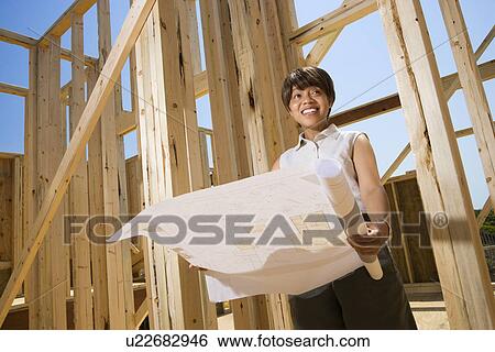 Woman Holding Building Plans View Large Photo Image Stock Photograph - Woman Holding Building Plans. Fotosearch