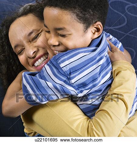Stock Photography - Woman Hugging Son. Fotosearch
