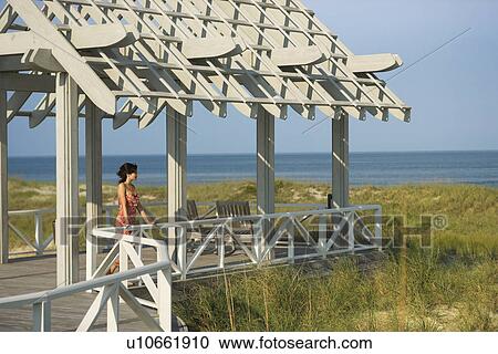 Stock Image - Woman on arbor looking at Sea. Fotosearch