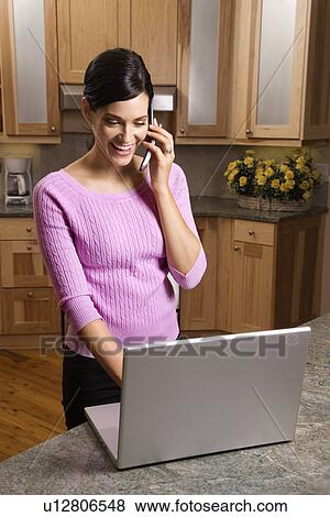 Woman on Cell Phone with Laptop View Large Photo Image Stock Photo - Woman on Cell Phone with Laptop. Fotosearch