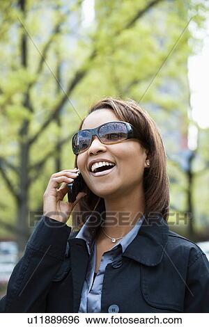 Stock Photograph - Woman on cellphone. Fotosearch
