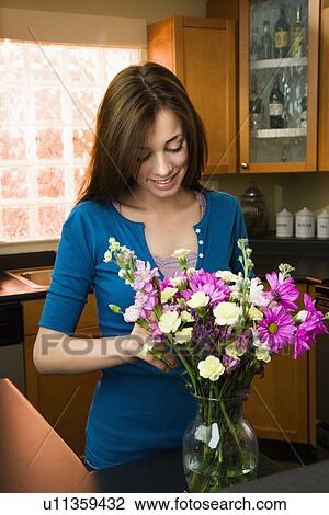 Woman putting flowers in vase View Large Photo Image Stock Image - Woman putting flowers in vase. Fotosearch