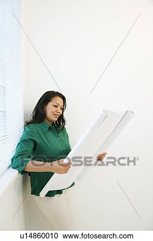 Woman reading blueprint. View Large Photo Image Stock Image - Woman reading blueprint.. Fotosearch