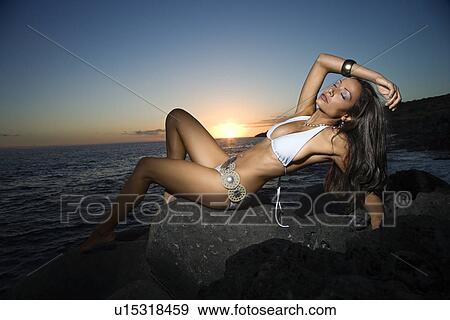 Woman Reclining in Swimsuit on Beach at Sunset View Large Photo Image Stock Photo - Woman Reclining in Swimsuit on Beach at Sunset. Fotosearch